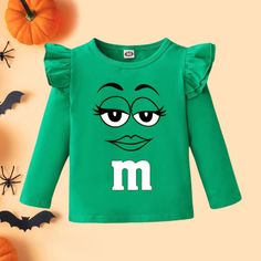 This Coated Candy "M" Tutu Set/Costume is pure sweetness! It's made of premium cotton for a comfortable fit, perfect for your little munchkin on Halloween! Make sure your Halloween night is poppin' with this oh-so-cute set, guaranteed to have your kid looking like the real candy coated deal. Fun Long Sleeve T-shirt For Playtime, Long Sleeve T-shirt With Character Print For Playtime, Sweet Cotton Tops For Playtime, Playful T-shirt For Fall Playtime, Playful T-shirt For Playtime In Fall, Green Cartoon Print Top For Fall, Playful Tops With Letter Print For Fall, Green Cartoon Print Tops For Fall, Playful Letter Print Tops For Fall