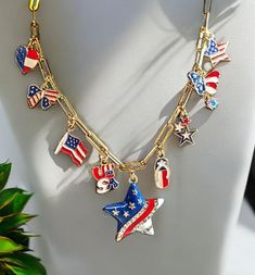 Celebrate Independence Day in style with this Custom Handmade Independence Day Charm Necklace. The chain  is made of Stainless Steel with 18 k Gold plating ,  16" in length with a 2" extender,  giving  18" of total length with a lobster claw closure. This necklace is a quality, durable piece that will not tarnish easily & is hypoallergenic making it a perfect accessory for those with sensitivities. The necklace features 9 charms, with a large star or heart charm as the center focal point.  This Patriotic Multicolor Dangle Jewelry, Patriotic Dangle Jewelry For Gifts, Nickel Free Dangle Jewelry For 4th Of July, Silver Jewelry Gift For 4th Of July, Silver Jewelry For 4th Of July Gift, Patriotic Dangle Jewelry For Independence Day, Patriotic Nickel-free Jewelry For 4th Of July, Handmade Patriotic Jewelry For 4th Of July, Handmade Patriotic Silver Jewelry