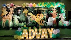 an image of a birthday backdrop with balloons and animals on the stage for children's birthday party