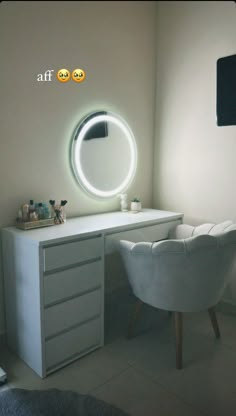 a white desk with a round mirror above it