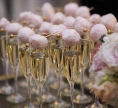 champagne flutes filled with pink and gold decorations