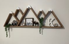 three wooden shelves with pictures and decorations on them