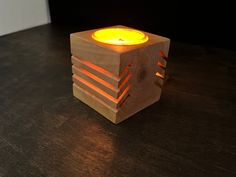 a wooden block with a lit candle in it