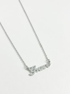 Our best selling personalised name necklace in silver is what we dream about. This necklace is the perfect every day name necklace. This silver name necklace is crafted from high quality stainless steel for a water and tarnish resistant finish. You can wear this custom piece every day. Custom Name Silver Jewelry In Stainless Steel, Silver Stainless Steel Custom Name Jewelry, Personalized Stainless Steel White Gold Necklace, Dainty Silver Custom Necklace As Personalized Gift, Personalized Stainless Steel Name Necklaces, Silver Nameplate Necklace For Everyday, Everyday Silver Nameplate Necklace, Silver Nickel-free Nameplate Necklace, Minimalist Stainless Steel Nameplate Necklace