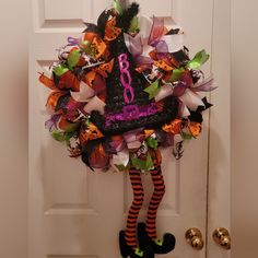 a halloween wreath hanging on the front door