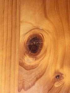 a wooden surface with holes in the wood