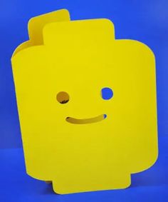 a yellow square shaped object with a smile on it's face and two eyes