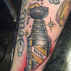 a tattoo on the leg of a person with a trophy