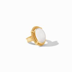 A polished oval gemstone in a golden beaded setting with an X motif and matching shank.