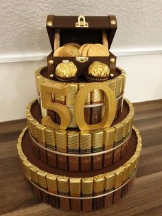 a cake made out of gold coins and chocolates with the number 50 on top