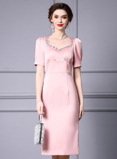 Flaunting a timeless elegance, this pastel pink dress is designed to capture attention with its subtle charm and sophistication. The dress features a beautifully tailored silhouette that gently hugs the body, providing a flattering fit for any figure. The bodice is adorned with delicate embroidery around the neckline, adding a touch of feminine grace and elegance. The puffed short sleeves offer a classic yet modern look, making the dress versatile for various occasions. The skirt falls gracefull Elegant Embellished Midi Dress For Wedding Guest, Feminine Evening Dress With Sweetheart Neckline, Square Neck Embellished Dresses For Formal Events, Elegant Pink Midi Dress For Formal Occasions, Elegant Short Sleeve Embellished Midi Dress, Pink Square Neck Formal Dress, Elegant Pink Midi-length Evening Dress, Pink Square Neck Dress For Banquet, Elegant Fitted Pink Evening Dress