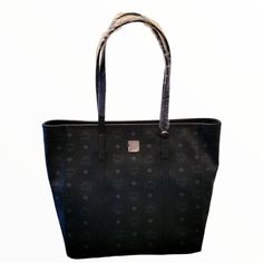 New With Tags Mcm Large Toni Tote Bag Exterior Pocket Printed Canvas Monogram Dust Bag Included 12.5 H 13" W 11" Drop High-end Black Bags For Daily Use, High-end Black Bag For Daily Use, High-end Coated Canvas Evening Bags, High-end Black Bag With Removable Pouch, Evening Tote Bag In Coated Canvas, High-end Black Bags With Branded Hardware, Evening Coated Canvas Tote Bag, High-end Black Shopping Bags, Formal Bags With Silver-tone Hardware In Coated Canvas