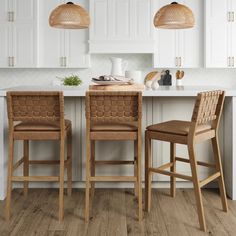 two wooden chairs sitting in front of a kitchen island