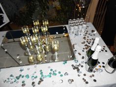 a table topped with lots of wine glasses and bottles