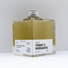 a bottle of tomy's margarita on a white surface with the label