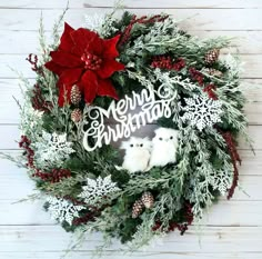 a christmas wreath with poinsettis, pine cones and snowflakes on it