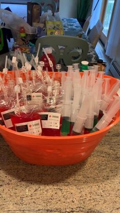 an orange bowl filled with lots of plastic bottles