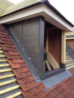 an open window on the roof of a house