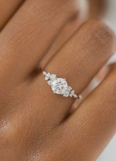 a woman's hand with a diamond ring on it