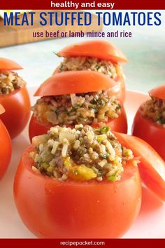 some stuffed tomatoes are on a plate with rice and vegetables in them to make an appetizer