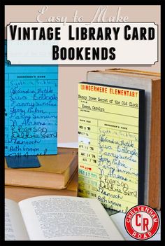 an open book sitting on top of a wooden table next to a pile of books