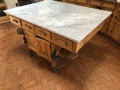 a kitchen island made out of wood and marble