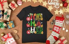 a t - shirt with the word christmas on it surrounded by presents