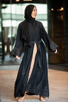 Premium Khaleeji Edition Open Abaya The Nawal Black Lace and Pearls Open Front Abaya is sophisticated and graceful! Featuring high quality nida fabric and black lace detailing with perfectly placed black pearls. You will be looking for an excuse to wear this beautiful abaya. Black Pearl and Lace Detailing Made in UAE 100% Nida Fabric Button closures to the thigh Fabric Belt and Hijab Included Model is 5'10" and wearing size M Open Front Maternity Friendly Nursing Friendly Wudu Friendly Ceremonial Clothing, Abaya Black, Open Abaya, Black Pearls, Pearl And Lace, Nursing Friendly, Fabric Belt, Kimono Sleeve, Off Black