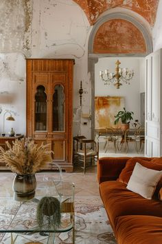 a living room filled with furniture and a chandelier