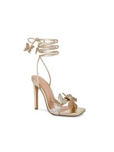 Elevate your style with these stunning Reina gold butterfly lace-up heels. Designed for the modern fashionista, these heels feature a striking butterfly motif that wraps elegantly around the ankle, adding a touch of whimsy and charm. The lace-up design provides a secure fit while showcasing an ultra-feminine silhouette. Crafted with a high stiletto heel, these sandals are perfect for special occasions, nights out, or adding a glamorous flair to any outfit. Details Elegant gold color with a gloss Gold Lace-up Sandals With Wrapped Heel For Evening, Luxury High Heel Lace-up Sandals For Spring, Gold Sandals For Spring Prom, Gold Lace-up Sandals For Evening, Elegant Lace-up Sandals With Block Heel For Evening, Gold Lace-up Sandals For Party, Gold Lace-up Party Sandals, Luxury Lace-up Sandals For Spring, Trendy Gold Heels For Evening