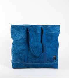 The Large East West Tote is perfect for grocery runs or weekend getaways, and it's washable. It effortlessly transforms from a handheld to a shoulder bag with detachable leather handles, making it washable too. (check the care instructions below, wink!). Crafted from Dark Indigo canvas, dyed by a family of textile artists in Western India, it undergoes a meticulous process of hand-dipping into a natural indigo vat up to 20 times to achieve the perfect shade of dark blue. Everyday Blue Canvas Bag With Reinforced Handles, Daily Use Waxed Canvas Shoulder Bag With Reinforced Handles, Everyday Travel Bag With Reinforced Double Handles, Everyday Travel Bag With Double Reinforced Handles, Blue Canvas Bag With Reinforced Handles For Everyday Use, Eco-friendly Waxed Canvas Travel Bag, Eco-friendly Travel Shoulder Bag With Reinforced Handles, Travel Shoulder Bag With Reinforced Handles In Waxed Canvas, Daily Use Waxed Finish Tote Travel Bag