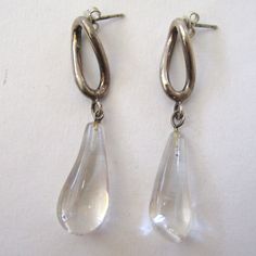 "Statement pair of earrings with a twisted sterling silver hoop and a large teardrop quartz stone dangling from the bottom. These are modern and elegant and will really carry an outfit. Marked 925 on the inside of the sterling twist. These are in excellent condition and measure 2 1/4\" long by just about 1/2\" across." Modern Clear Drop Jewelry, Modern Pierced Drop Teardrop Earrings, Formal Clear Teardrop Earrings, Modern Clear Teardrop Jewelry, Modern Sterling Silver Teardrop Earrings For Formal Events, Sterling Silver Long Drop Teardrop Earrings For Formal Occasions, Modern Sterling Silver Teardrop Earrings For Formal Occasions, Modern Pierced Drop Earrings For Formal Occasions, Modern Formal Dangle Drop Earrings