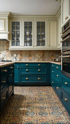 a kitchen with blue cabinets and patterned flooring