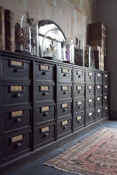 an old dresser with lots of drawers in it