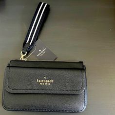 Kate Spade Rosie Pebbled Leather Medium Wristlet Wallet In Black Nwt Beautiful Leather Wristlet With Front Flap Magnetic Closure Pocket & Main Zipper Compartment. Inside Features Credit Card Slots And Plenty Of Room For The Essentials. Fun Black And Write Wristlet Strap Of ~6.5” Long. Wristlet Strap Is Removable For Extra Versatility. Approx 4.8” H X 8” W X 1.2” D Nwt Kate Spade Rosie Pebbled Leather Medium Flap Wristlet Wallet In Black Kate Spade Leather Backpack, Kate Spade Laptop Bag, Baby Tote Bag, Kate Spade Purse Black, Kate Spade Shoulder Bag, Bags Kate Spade, Medium Handbags, Kate Spade Wallet, Kate Spade Purse