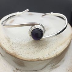 A simplistic and elegant sterling silver bracelet cuff, with an 8mm gemstone cabochon of your choosing in the drop down menu! This is shown with a few different stone colors and I can accommodate if preferred. Also, when ordering, please tell me your wrist size so I can have this fit you perfectly! Shipping is First Class with Delivery Confirmation, within the US, and First Class International outside. *SIZING GUIDE* Take a snug wrist measurement and add 1 inch to determine which size to order. Silver Amethyst Gemstone Cuff Bracelet, Silver Amethyst Gemstone Bangle, Adjustable Sterling Silver Cuff Bracelet With Cabochon, Silver Sterling Silver Cuff Bracelet With Cabochon, Adjustable Sterling Silver Cabochon Cuff Bracelet, Elegant Sterling Silver Bracelet With Cabochon, Adjustable Cabochon Sterling Silver Cuff Bracelet, Elegant Silver Amethyst Cuff Bracelet, Sterling Silver Bangle Bracelets With Cabochon