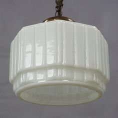 a white light fixture hanging from a ceiling