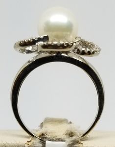 "Vintage 14K White Gold Pearl & Diamond Ring, Size 7.25. Stamped 14K JI inside band. Pearl is 8mm. No missing stones. Weighs 2.1 dwt. Please stop in often as we will be adding additional vintage fine jewelry beauties. Note that the letter/number combo in the title is for our purposes only. We do not check prongs for wear or stones for looseness. All items are sold as is-noting that we are a resale shop so everything here had a previous owner! We will include flaws in the description when not Elegant Formal Flower Ring With Diamond Cut, Formal Flower Ring With Diamond Accents, Elegant Flower Ring With Polished Finish For Anniversary, Classic Diamond Cut Flower Ring For Formal Occasions, Elegant Wide Band Ring Stamped 14k, Elegant 14k Stamped Wide Band Ring, Classic White Gold Flower Ring For Formal Occasions, Classic White Gold Flower Ring For Formal Events, Formal Diamond Cut Flower Ring