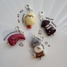 four charms with different types of food on them