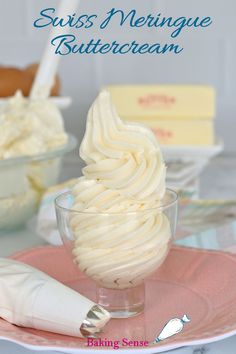 a plate topped with whipped cream on top of a pink saucer next to other desserts