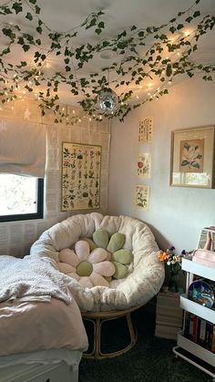 a bedroom with a bed and some plants on the ceiling