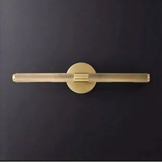 a close up of a door handle on a black wall with a gold colored finish