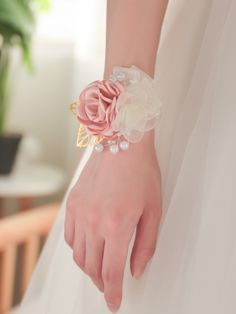 a close up of a person wearing a bracelet with flowers on it