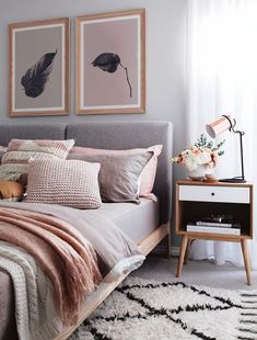 a bedroom with two framed pictures above the bed