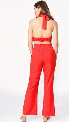 Vena Crepe Red Halter Jumpsuit , a show-stopping style down to the last detail. This woven crepe jumpsuit features a halter neckline, open back with scrunchie strap detail, hidden side pockets and wide leg. Invisible zipper along the back.Vena Crepe Red Halter Jumpsuit is by Adelyn Rae. Vena Crepe Red Halter Jumpsuit Details: Halter jumpsuit Open back Wide leg Side pockets Scrunchie strap Invisible zipper closure Lined Size small Inseam: 29" medium: 30” large: 31” Bust small width: 16 1/2" medium: 17 1/2” large: 18 1/2” Waist: small 28” medium 30” large 32” Self: 97% Polyester, 3% Spandex Lining: 100% Polyester Model is wearing a size small Summer Workwear Halter Neck Jumpsuits And Rompers, Summer Workwear Halter Neck Jumpsuit, Chic Wide Leg Jumpsuits And Rompers With Tie Back, Red Backless Spring Jumpsuits And Rompers, Red Backless Jumpsuits And Rompers For Spring, Chic Red Backless Jumpsuits And Rompers, Chic Red Backless Jumpsuit, Backless Summer Jumpsuits And Rompers For Work, Backless Jumpsuits And Rompers For Summer Workwear