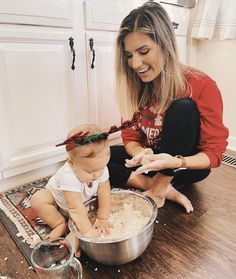 a woman and her baby are mixing food together