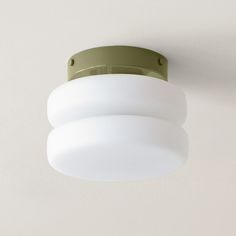 a close up of a light fixture on a ceiling with a white wall in the background