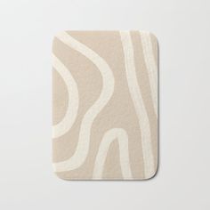 a beige and white coaster with wavy lines