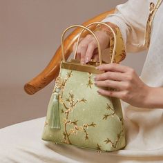 Description Inspired by the serene beauty of pear blossoms, our silk floral bag embodies the purity and tranquility found in nature's simplest yet most exquisite moments. Just as the pear trees blossom with a gentle, clear radiance, our design captures this essence with its clean and elegant lines. The bag’s pristine white hue mirrors the pure and unadorned charm of pear blossoms, offering a refreshing and refined aesthetic. Even amidst a flurry of activity, this design maintains a sense of calm Luxury Green Bag For Spring, Elegant Top Handle Bags For Spring, Spring Rectangular Evening Bag With Removable Pouch, Elegant Spring Rectangular Bags, Gold Bags For Spring Gift, Elegant Rectangular Spring Evening Bag, Elegant Gold Bags For Spring, Elegant Rectangular Evening Bag For Spring, Green Shoulder Bag For Formal Spring Occasions