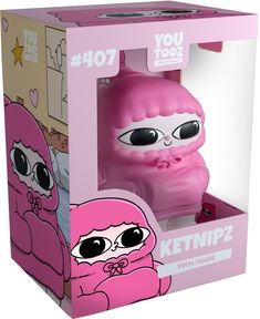 a pink toy with big eyes in a box